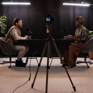 Dynamic podcast session featuring two hosts with studio lighting and recording equipment.